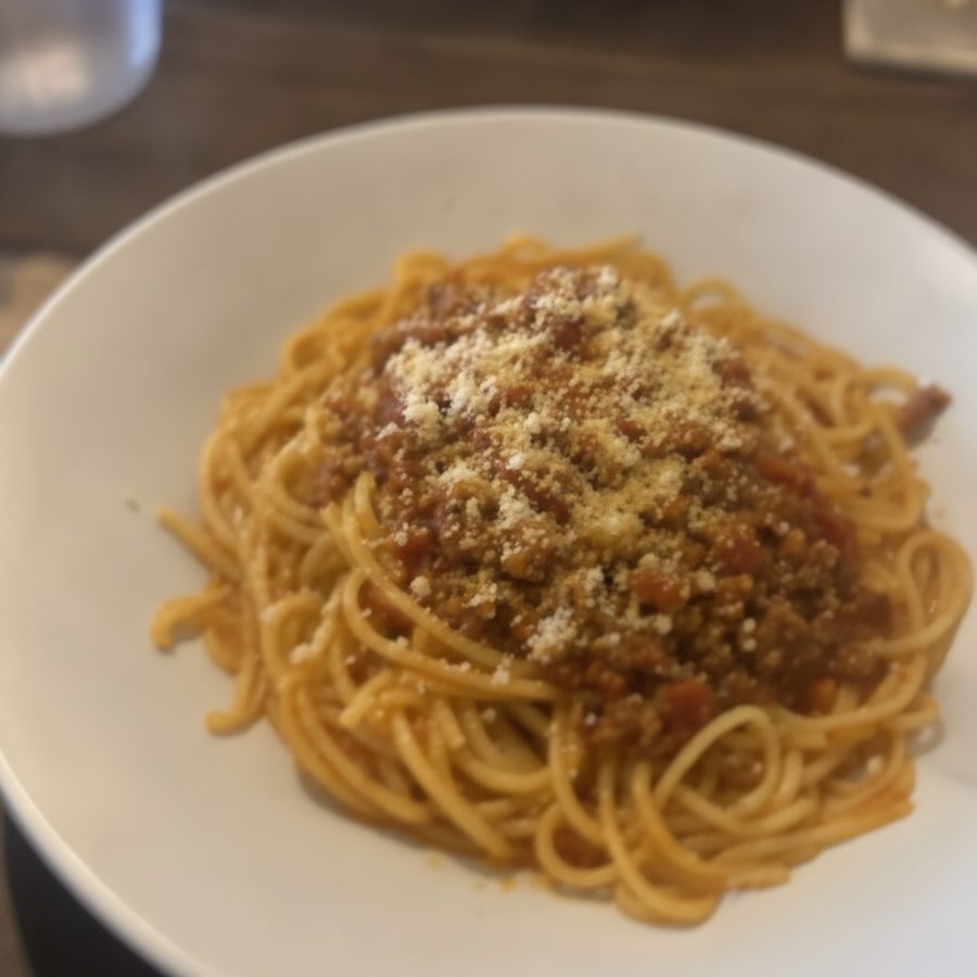 The same spaghetti bolognese shown sharp and in focus after a steady reshoot
